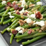 NOT YOUR MAMAS GREENBEANS - Fresh green beans topped with a Dijon Mustard Balsamic glaze, pecans, dried cranberries and feta cheese #thanksgiving #thanksgivingsides #greenbeans