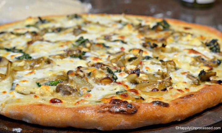 slice of caramelized onion, mushroom, feta pizza with white cream sauce