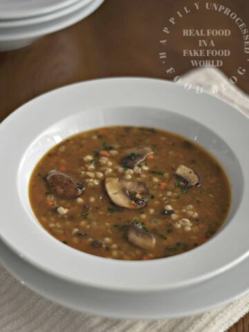 white bowl of mushroom barley soup happilyunprocessed
