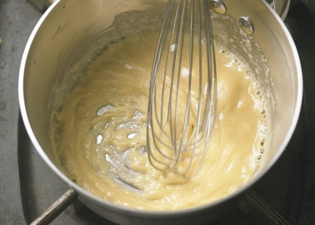 a saucepan with flour and milk to make a roux