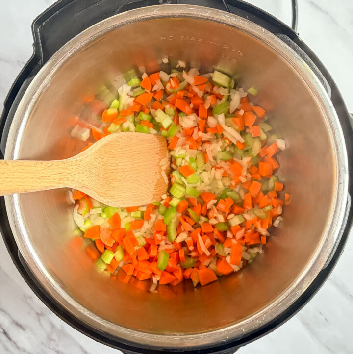 sautéed vegetables in instant pot with wooden spoon