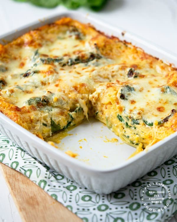 White casserole dish with butternut squash and spinach lasagna