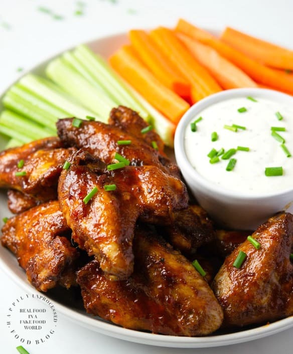 Fall off the Bone Crockpot Honey Buffalo Wings - no frying, no mess. Slow cooked until tender and finished under the broiler with a tangy, spicy, delicious honey buffalo sauce #chickenwings #wings #football #gameday #appetizers #happilyunprocessed