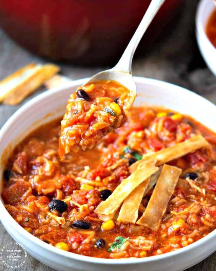 CHICKEN TORTILLA SOUP WITH RICE - perfect blend of Mexican spices, shredded chicken, corn, beans and rice for a filling bowl of soup #soup #chickentortilla #healthy #happilyunprocessed
