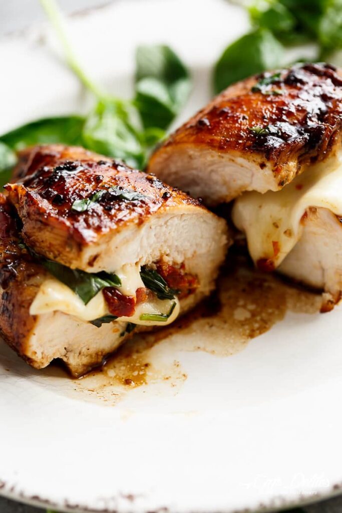 CAPRESE CHICKEN - Thin chicken breasts stuffed with sun dried tomatoes, mozzarella cheese topped with a sweet balsamic glaze #capresechicken #chicken #weeknightdinner #cleaneating #happilyunprocessed