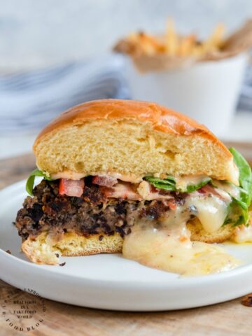 STUFFED BLACK BEAN BURGER with Monterey Jack Cheese - seasoned black beans, diced veggies, spices and cheese make up this delicious meat alternative burger #blackbeanburger #impossiblemeat #vegetarian #dinner #grill #happilyunprocessed