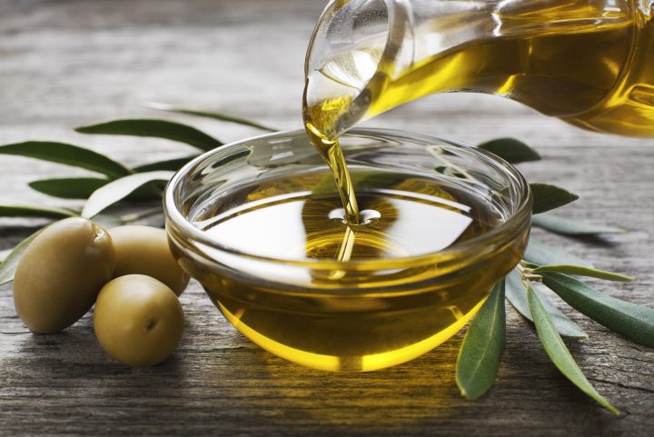 pouring olive oil in a dish