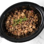 Slow cooker stuffing with sausage, cranberries, herbs and pecans. No turkey needed! The slow cooker makes the moistest best stuffing ever! #stuffing #thanksgiving #thanksgiving side dish # turkey #side dish