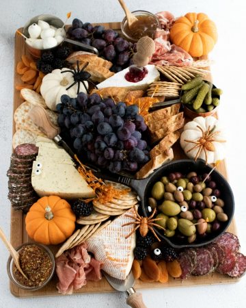Fall Charcuterie Board with olives, cheeses, meats, pumpkins