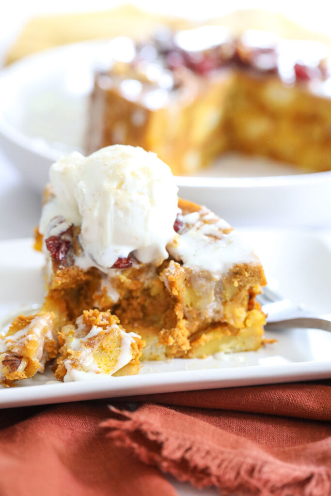 Instant Pot Pumpkin Bread Pudding on a plate with melted vanilla ice cream on top
