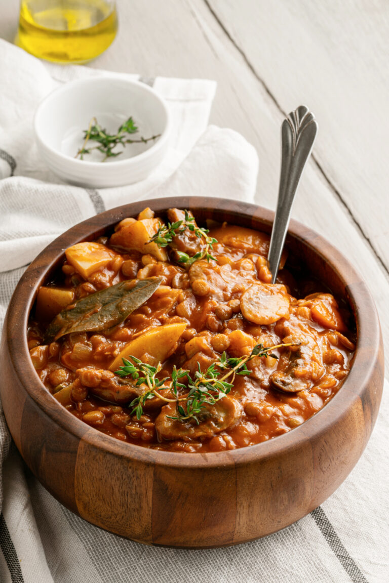 Vegetarian Lentil Mushroom Stew in a wooden earth toned bowl