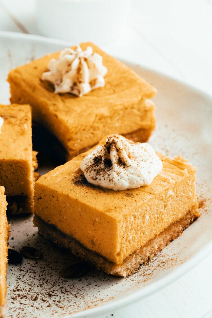 pumpkin cheesecake bars with whipped cream on top 683x1024 - Gluten Free Pumpkin Cheesecake Bars