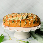 Spinach Artichoke Pull Apart Bread on a white serving platter