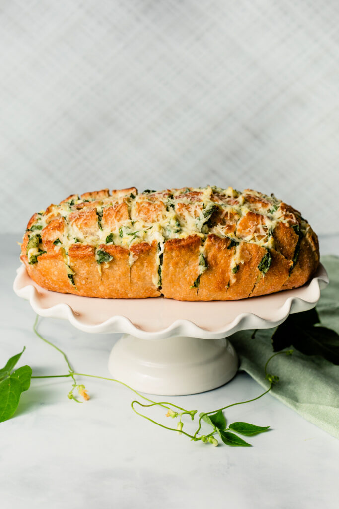 Spinach Artichoke Pull Apart Bread on a white serving platter