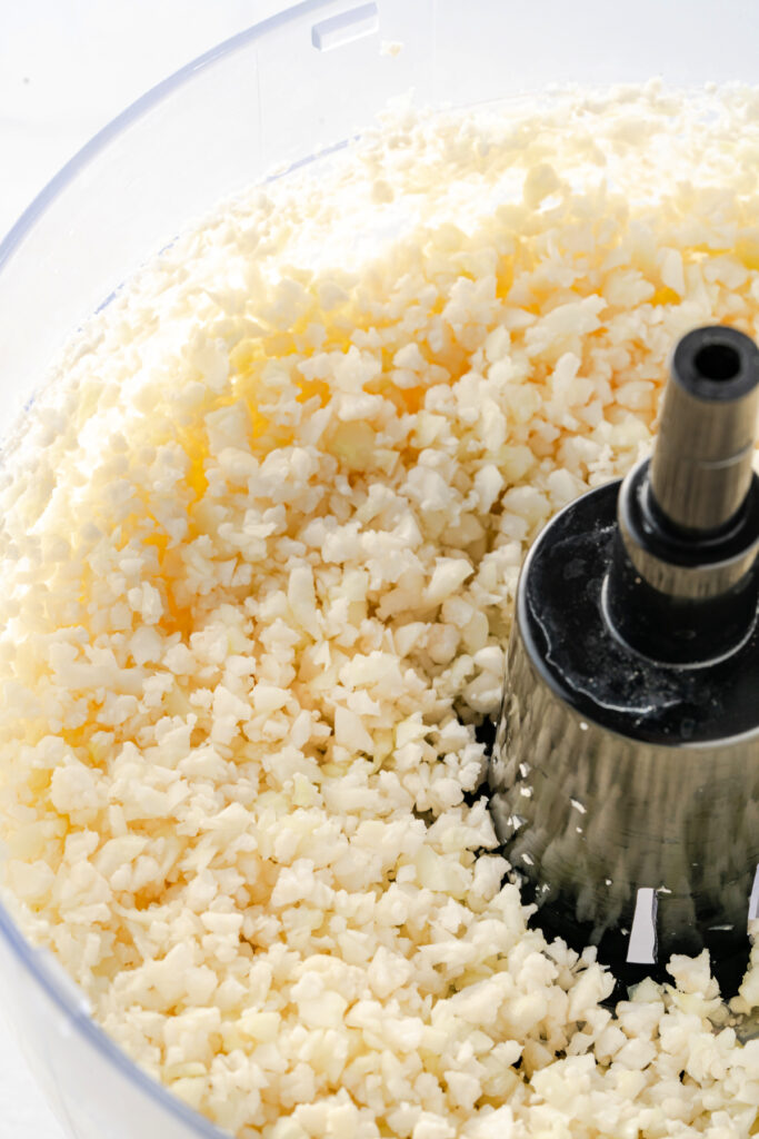 Cauliflower rice in a food processor chopped up