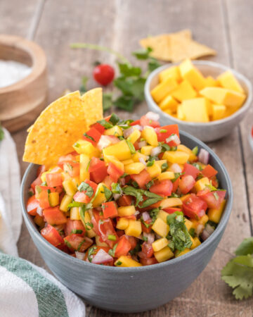 A big bowl of mango pico de gallo with tortilla chips is a healthy gluten-free vegan appetizer