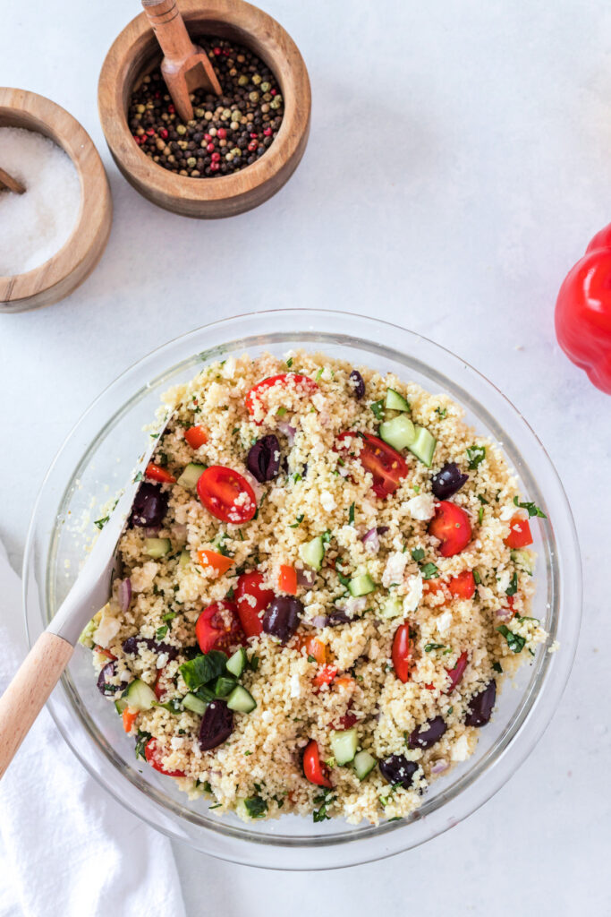 Mediterranean couscous with quinoa in a glass bowl