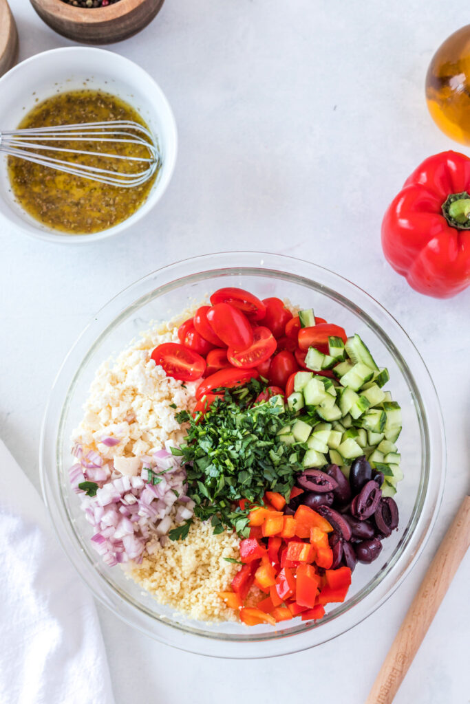 Mediterranean couscous with quinoa chopped ingredients in a bowl