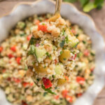 a spoonful of a delicious healthy quinoa salad with chickpeas and olives