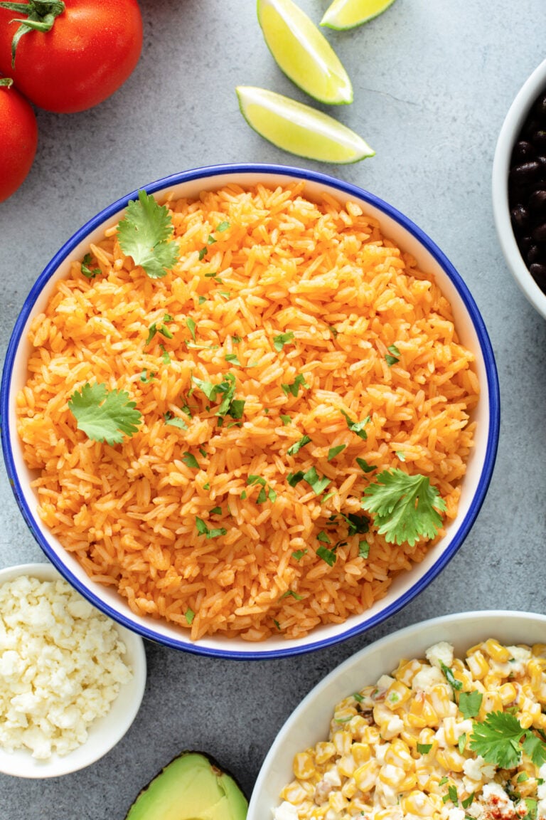 Homemade Yellow Mexican Rice in a blue bowl with fresh cilantro