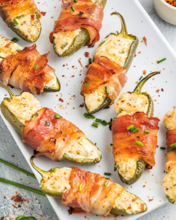 a-plate-of-garlic-and-chive-herbed-cream-cheese-jalapeno-poppers-wrapped-in-bacon-on-a-plate-