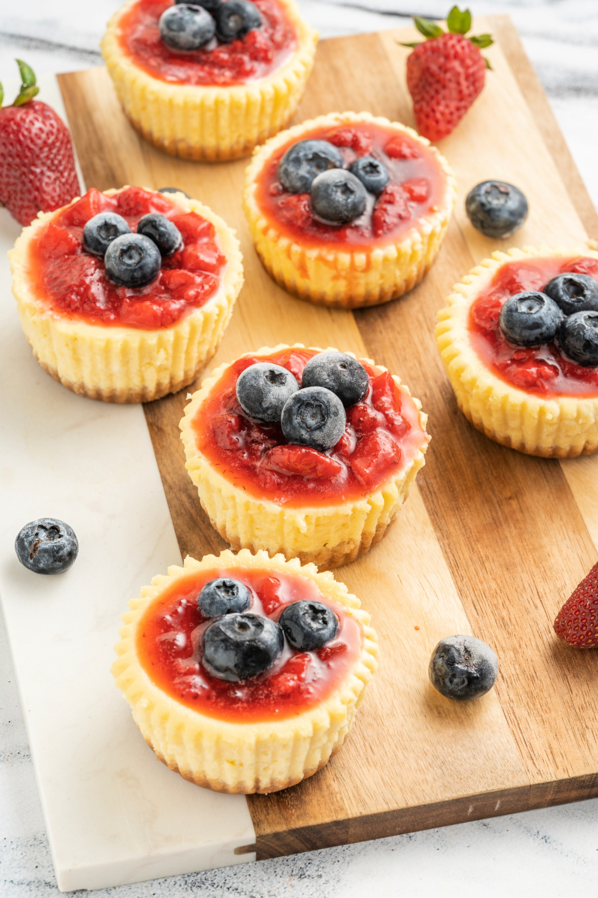 Delicious mini cheesecakes with a graham cracker crust and blueberries on top
