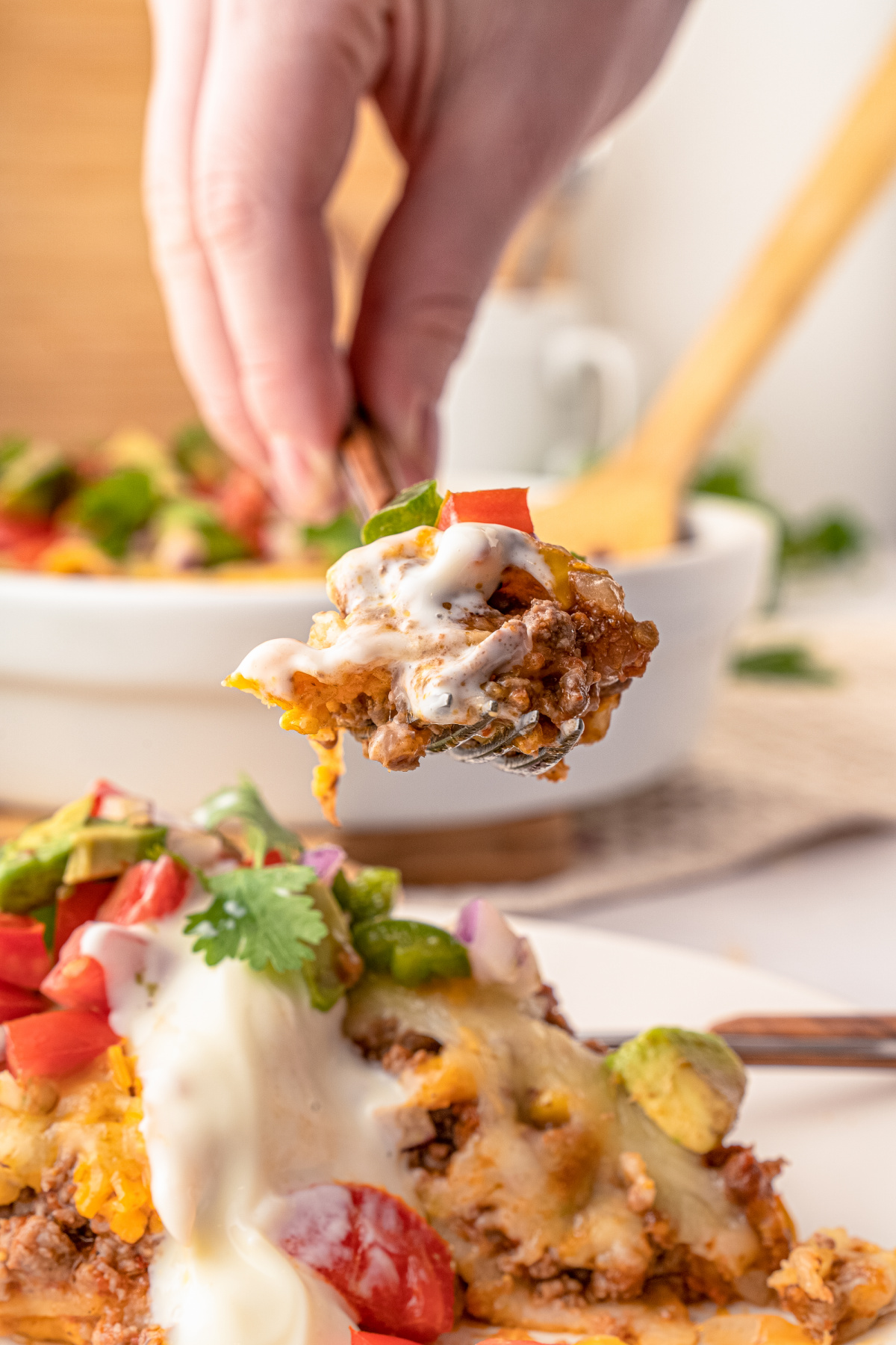Layered Mexican Taco Lasagna Casserole with ground beef, beans, tomatoes and cheese