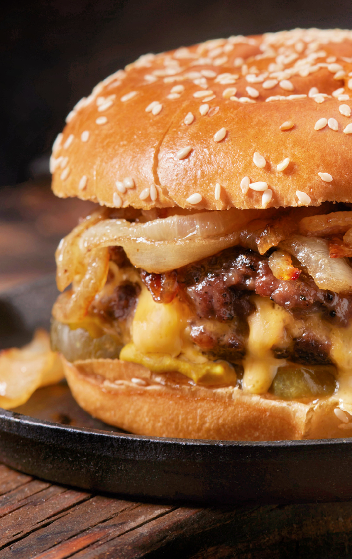 The ultimate juicy smash burger with fried onions on a sesame seed bun