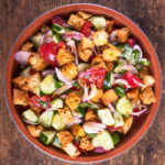 Panzanella salad with crusty stale bread, tomatoes, cucumbers and red onion