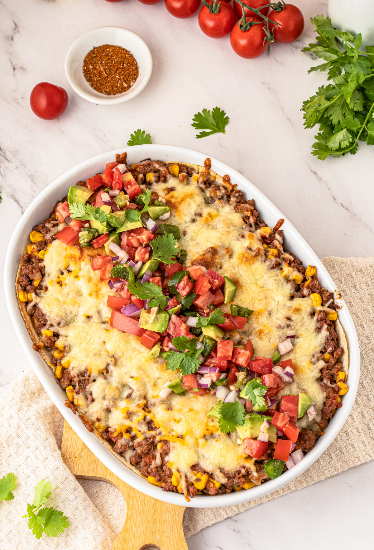 Layered Mexican Taco Lasagna Casserole with ground beef, beans, tomatoes and cheese