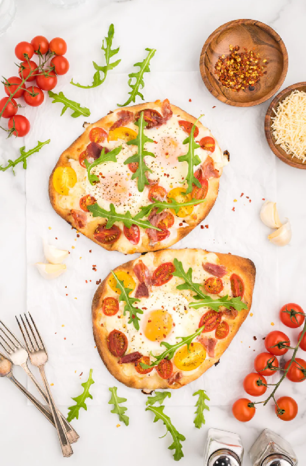 Flatbread Breakfast Pizza with a fried egg, cherry tomatoes and arugula