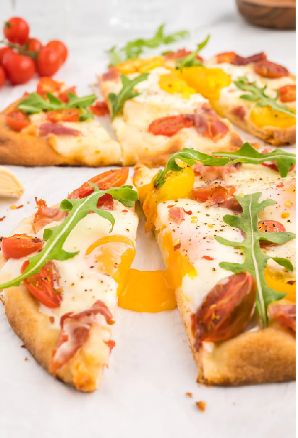 Flatbread Breakfast Pizza with a sunny side up egg and arugula