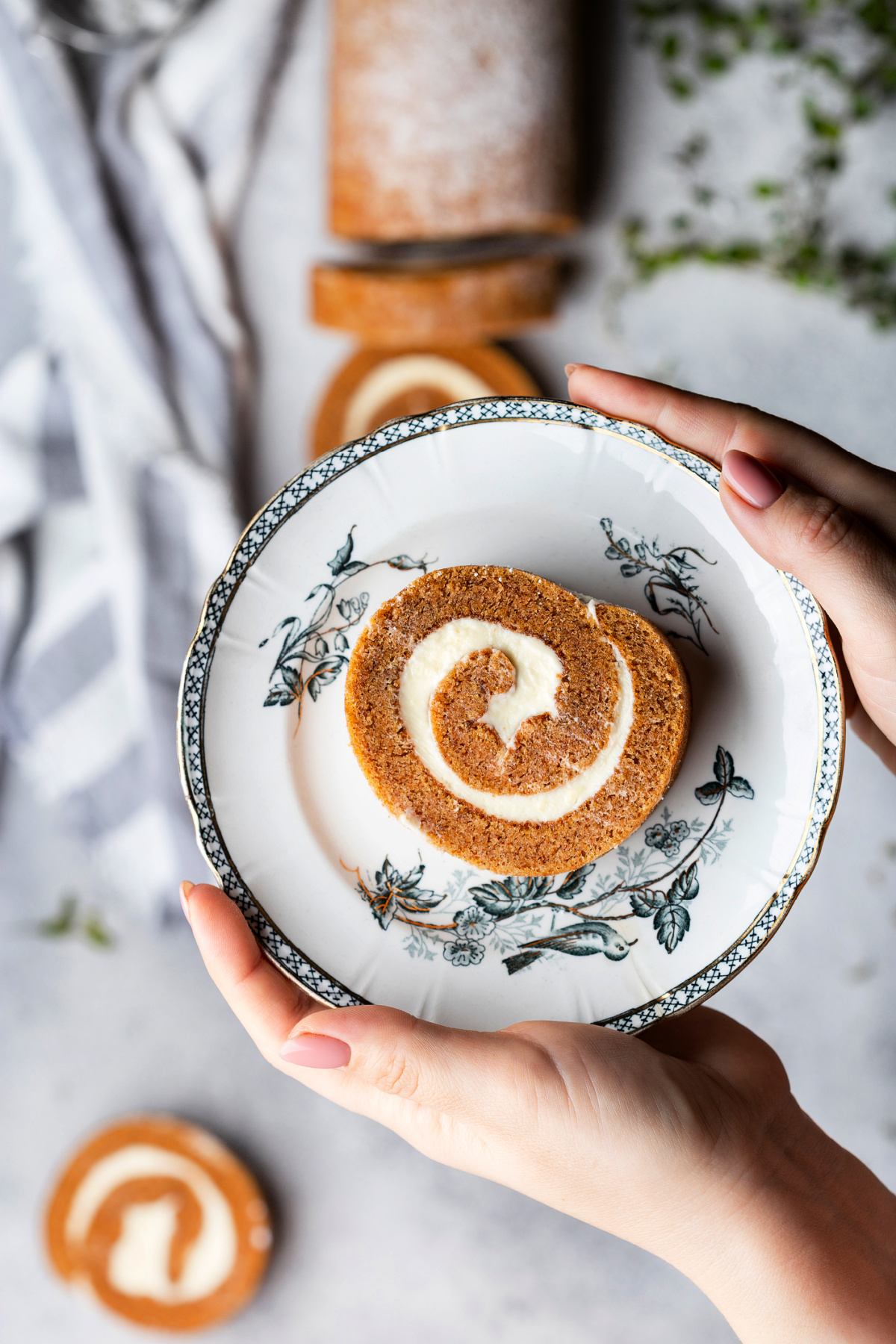 A slice of perfectly made pumpkin roll with a cream cheese filling