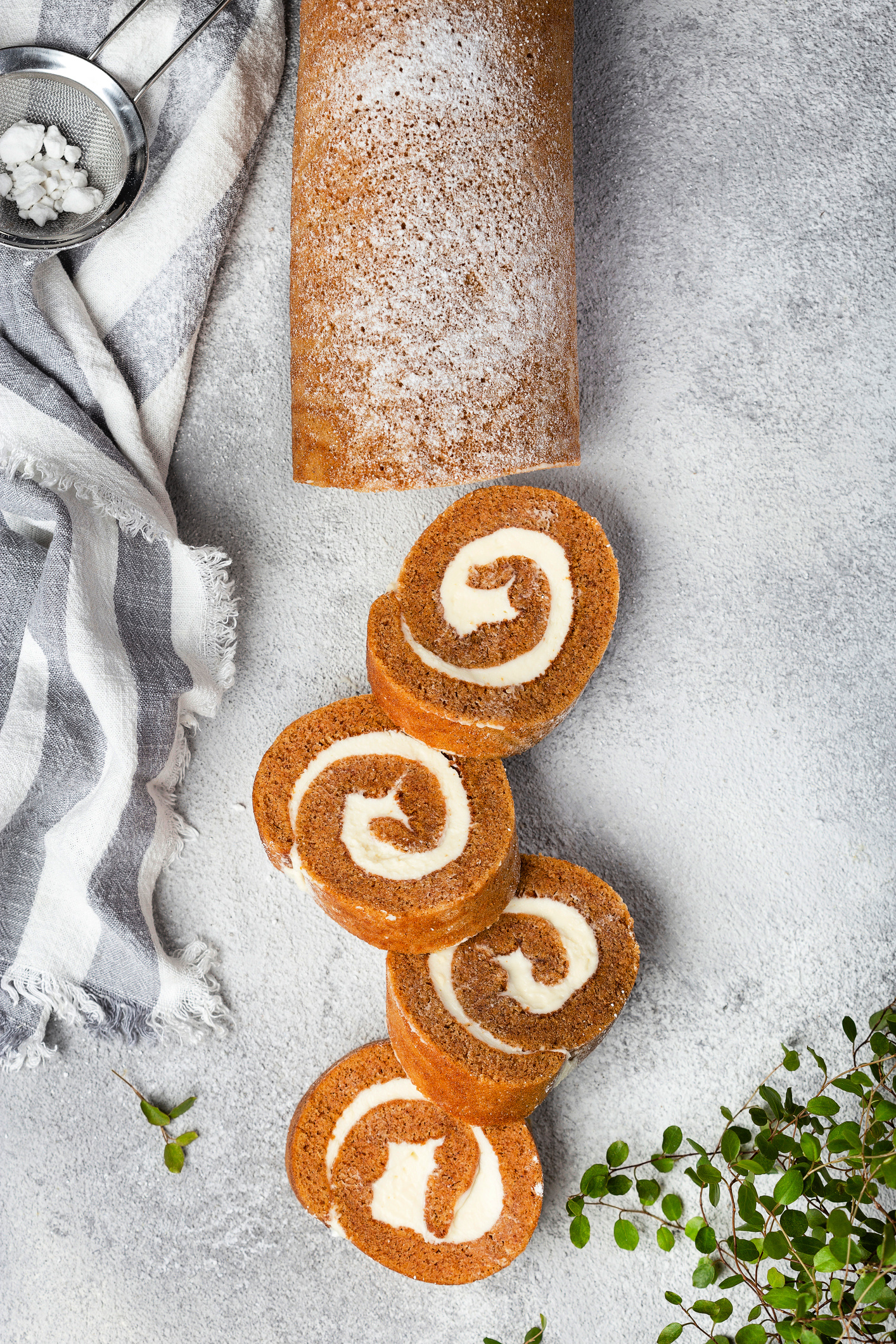 Pumpkin cake roll with cream cheese filling and powdered sugar