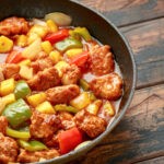 Sweet and sour chicken with pineapple and bell peppers over rice