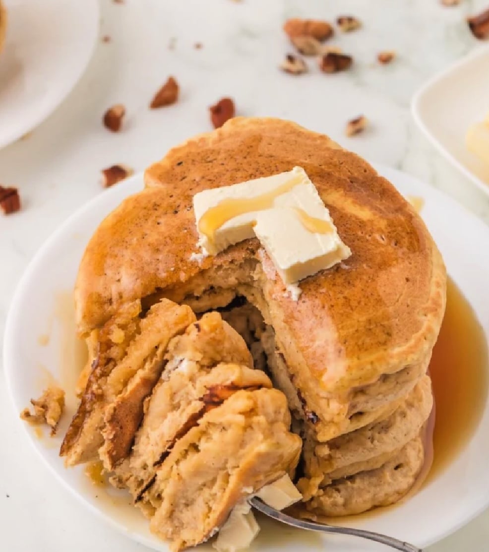 pumpkin pancake stack that has been cut and show the fluffy inside