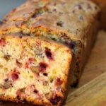 Mom's Cranberry Walnut Bread slice of cranberry walnut bread on cutting board