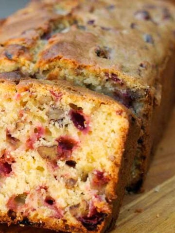 slice of cranberry walnut bread on cutting board