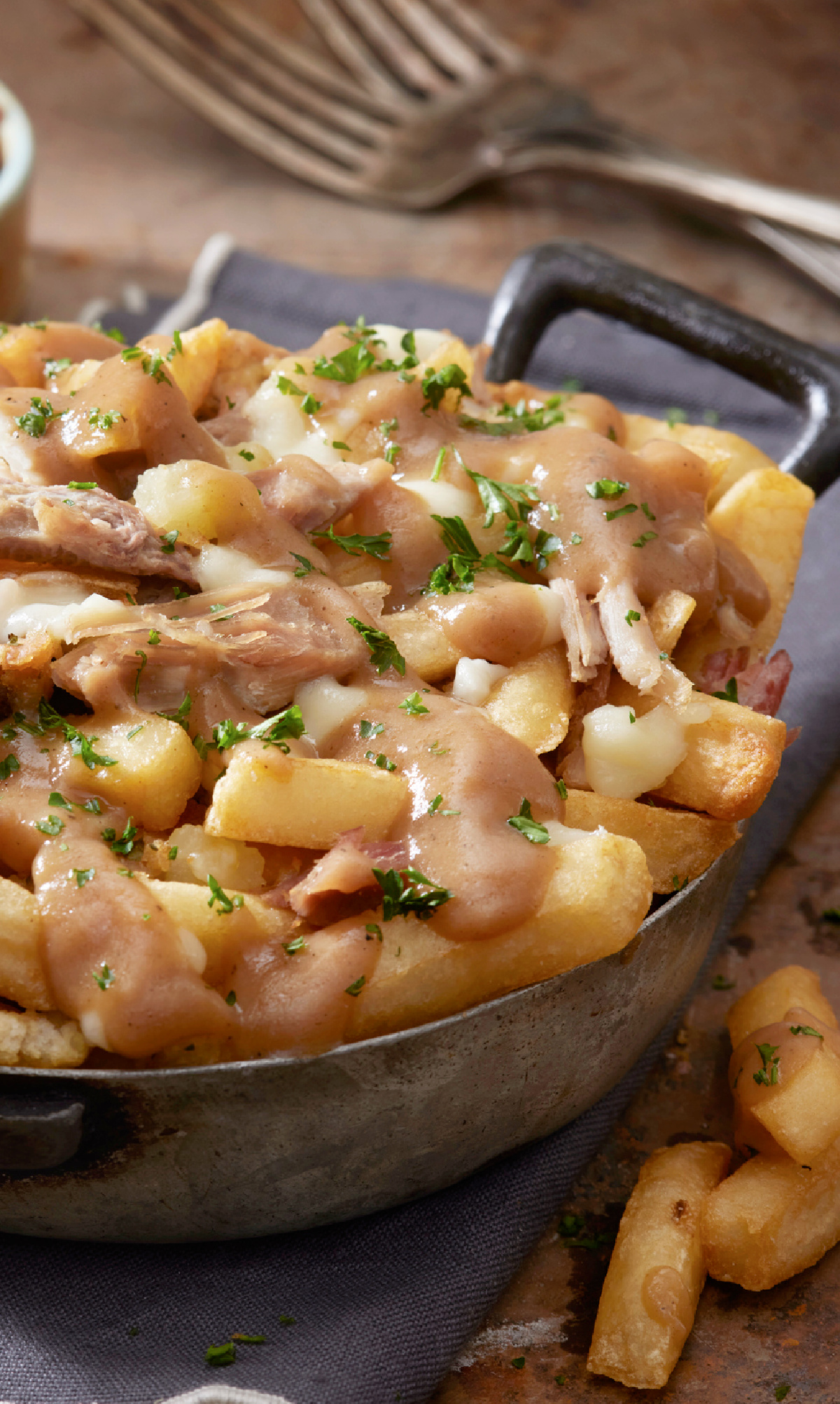 Classic Canadian Poutine with shredded leftover Thanksgiving turkey, cheese curds and gravy