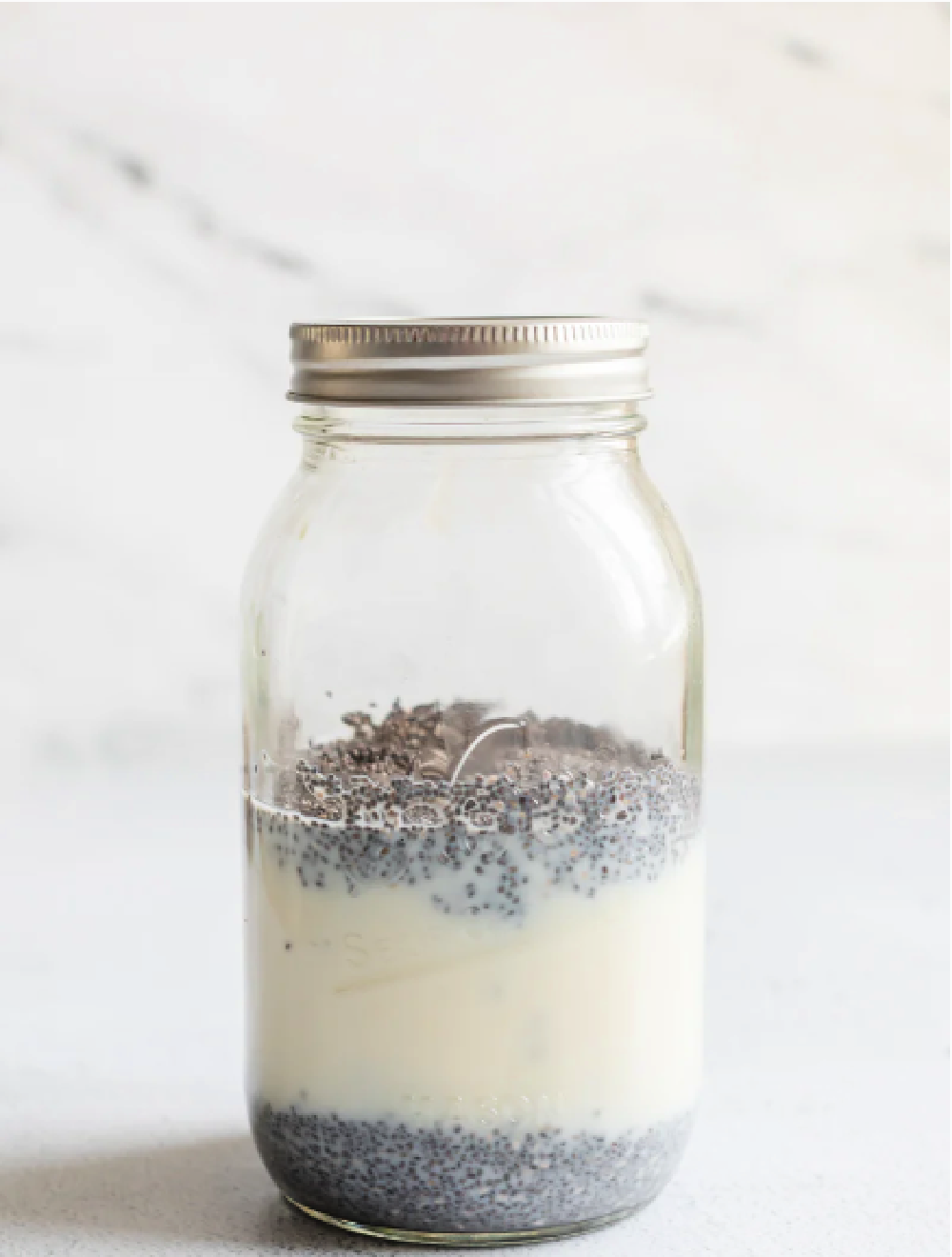 a mason jar with chia seeds, coconut milk, almond milk and vanila
