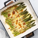 Roasted Asparagus with Garlic and Mozzarella Asparagus topped with garlic and mozzarella in a baking dish