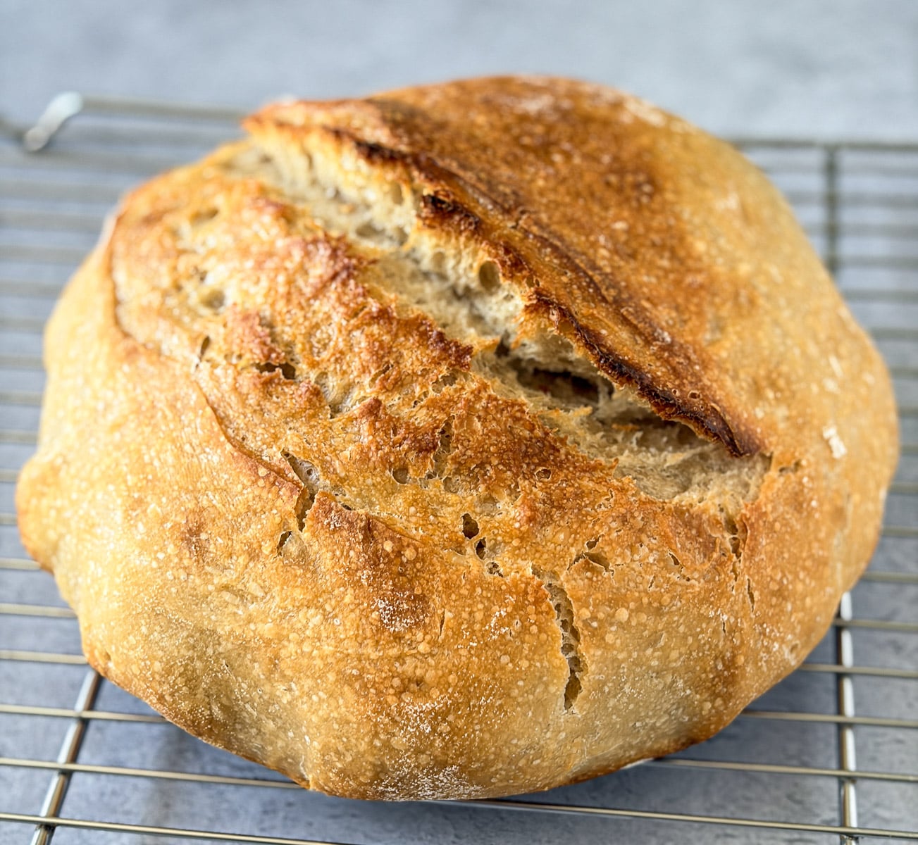 Sourdough bread loaf on cooling rack