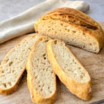 Sourdough bread loaf and slices on a cutting board