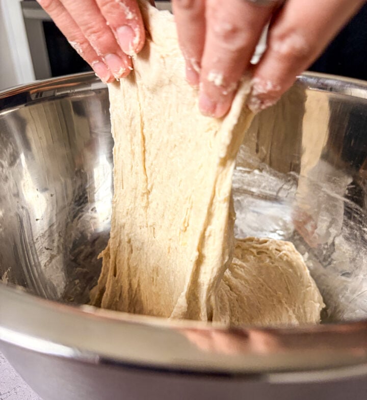 Stretching sourdough in a stainless steel bowl